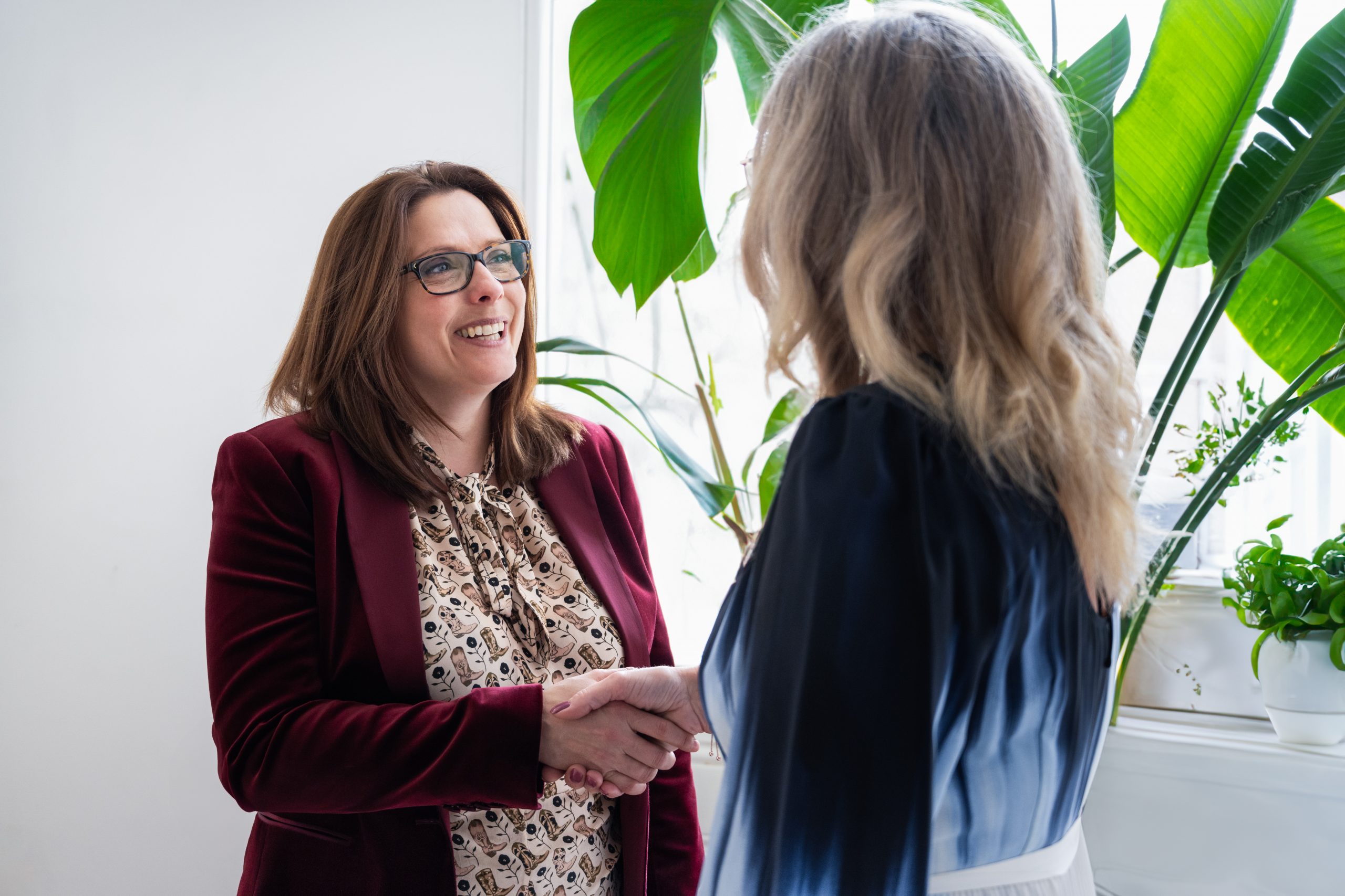 Two women shaking hands